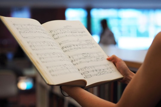 Client perusing music book at the State Library of Queensland. Photo by Emma Winch.