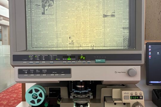 Minolta microform reader machine displaying newspaper
