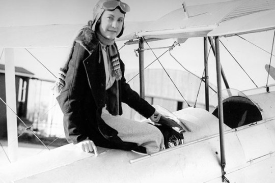 Ivy May Hassard sitting in the cockpit of an air craft, ca.1935