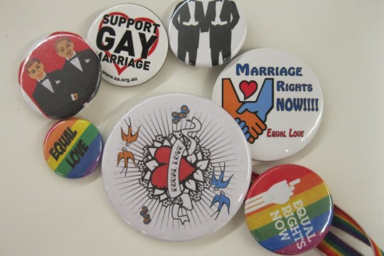 An assortment of badges from the Equal Love Brisbane collection held by State Library of Queensland