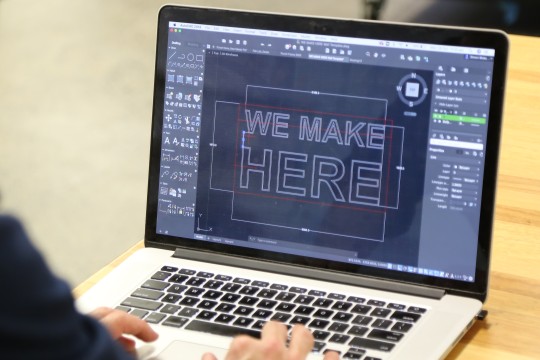 Laptop with we make here text