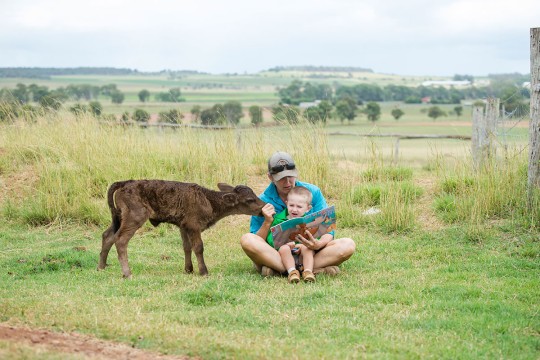 Mother and son reading on farm