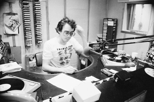A photo of a 4ZZZ radio announcer in the studio