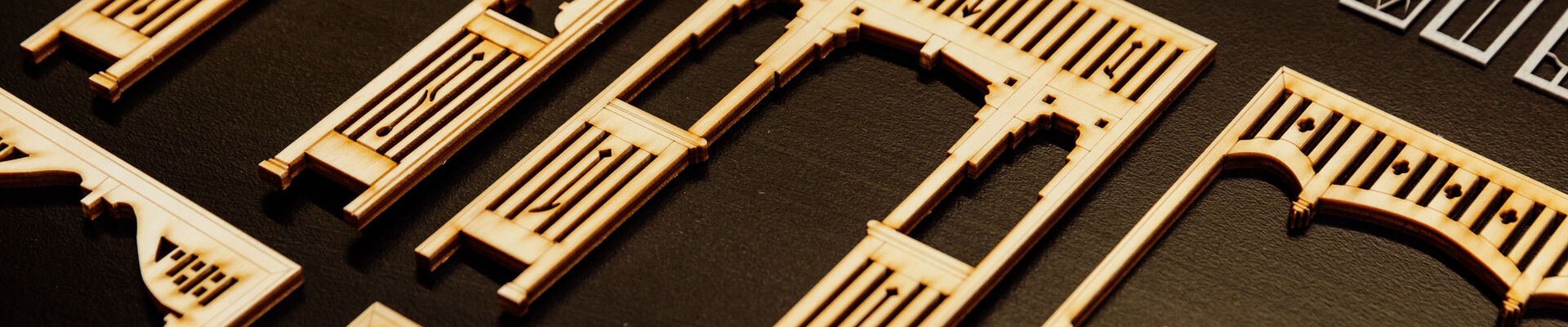 A photo of a row of laser cut miniature archways