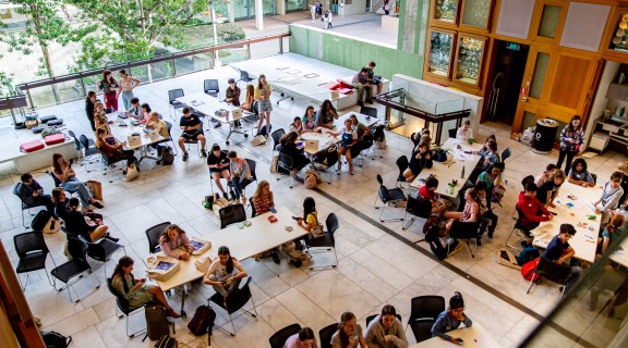 Children sitting around tables at a worksohp