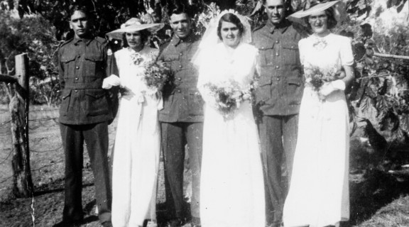 Wedding photo of three First Nations couples with the men all in service uniforms
