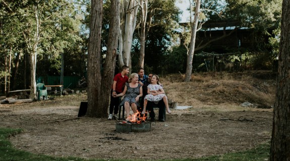 Jeurgen and Vicki Landmann sitting with their three children around a firepit during the height of COVID-19 restrictions in Brisbane April 2020.