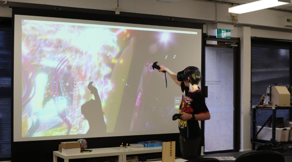Young person painting with a VR headset on