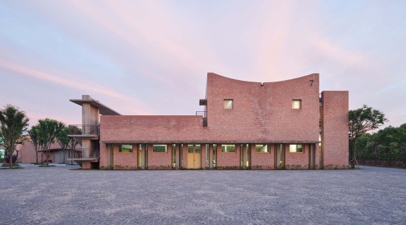 a terracotta coloured low set building