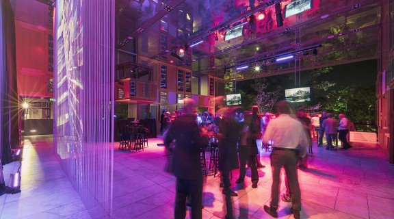 A group of men attending a cocktail party on the Queensland Terrace at State Library