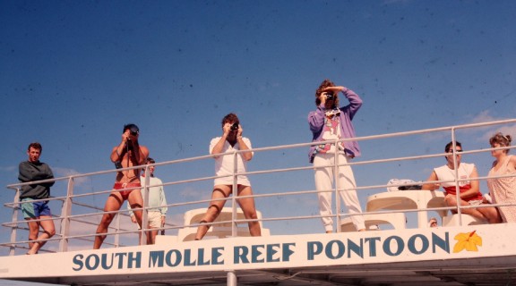 Three photographers on the South Molle Reef pontoon, Whitsundays Region