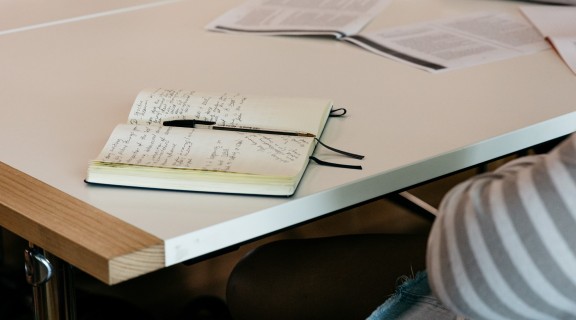 Notebook with notes on table.