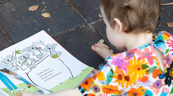 Girl reading Stories for Little Queenslanders