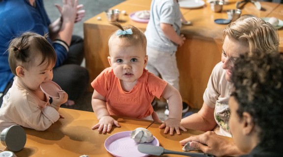 Children and families play with clay