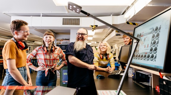 People learning how to use the laser cutter in the Edge.