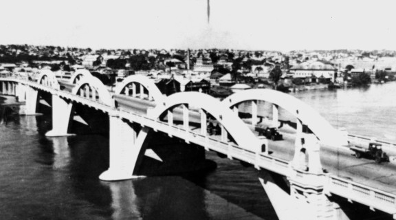 William Jolly Bridge, Brisbane. An old black and white image of the bridge taken from a distance.