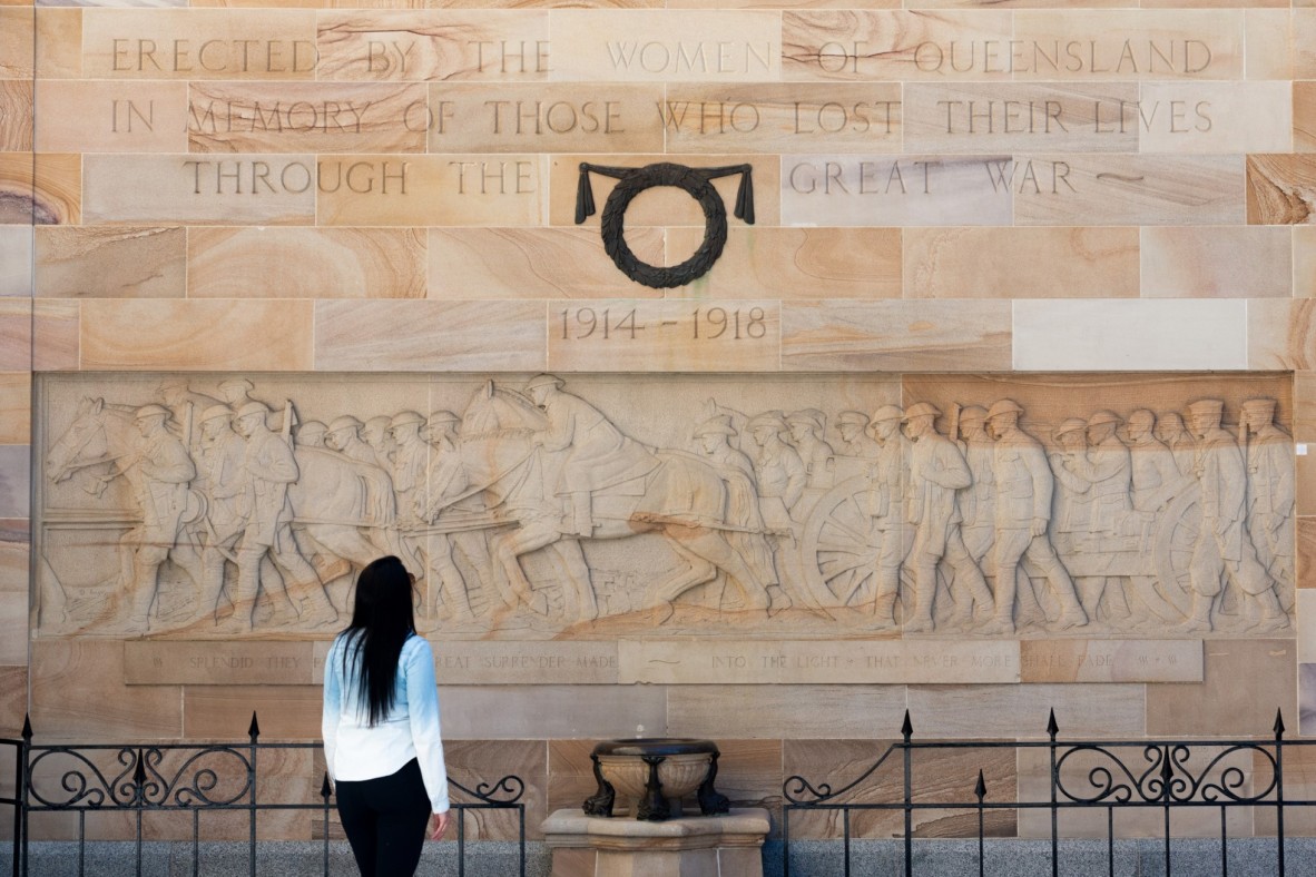 Photo of a person standing in front of the Women’s Memorial at Anzac Square