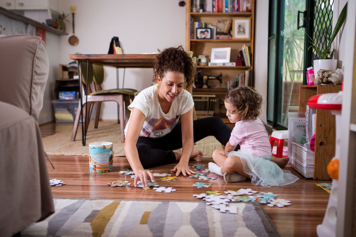 Mum and daughter playing with jigsaw puzzle.