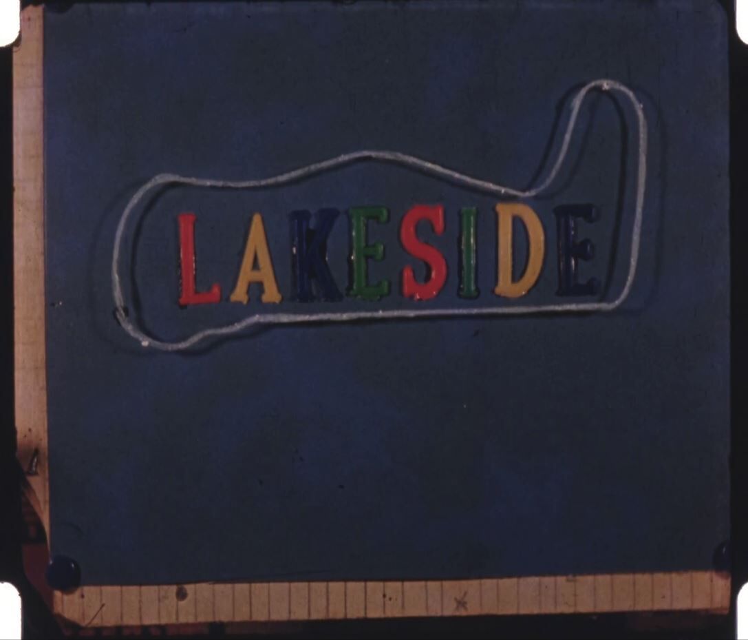 Title page from home movie showing the word Lakeside arranged in plastic colour letters