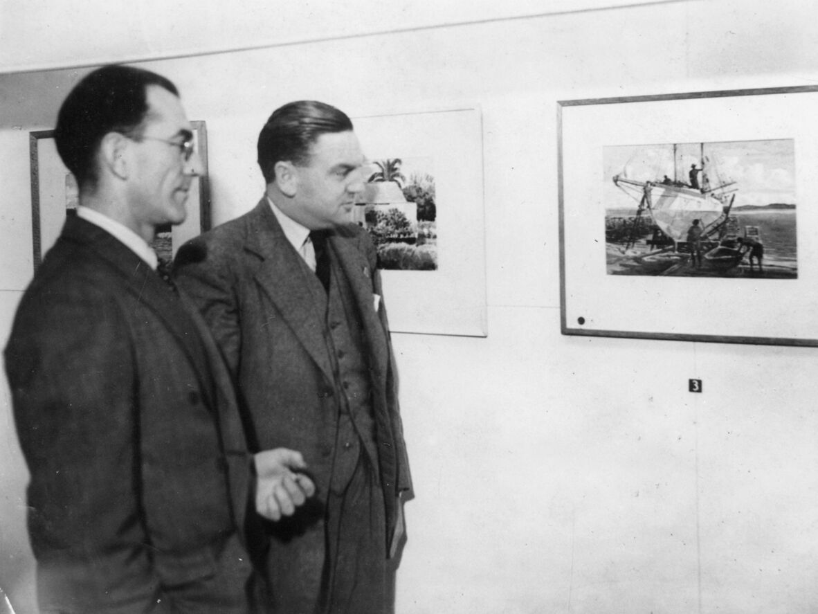 James Wieneke photographed in front of his work in the Moreton Galleries, 1950.