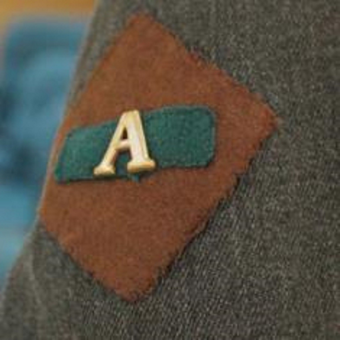 Chocolate star and green stripe with a brass 'A' matching Greta Towner’s service uniform with the No 1 Australian General Hospital and at Lemnos. The 'A' is for Anzac.