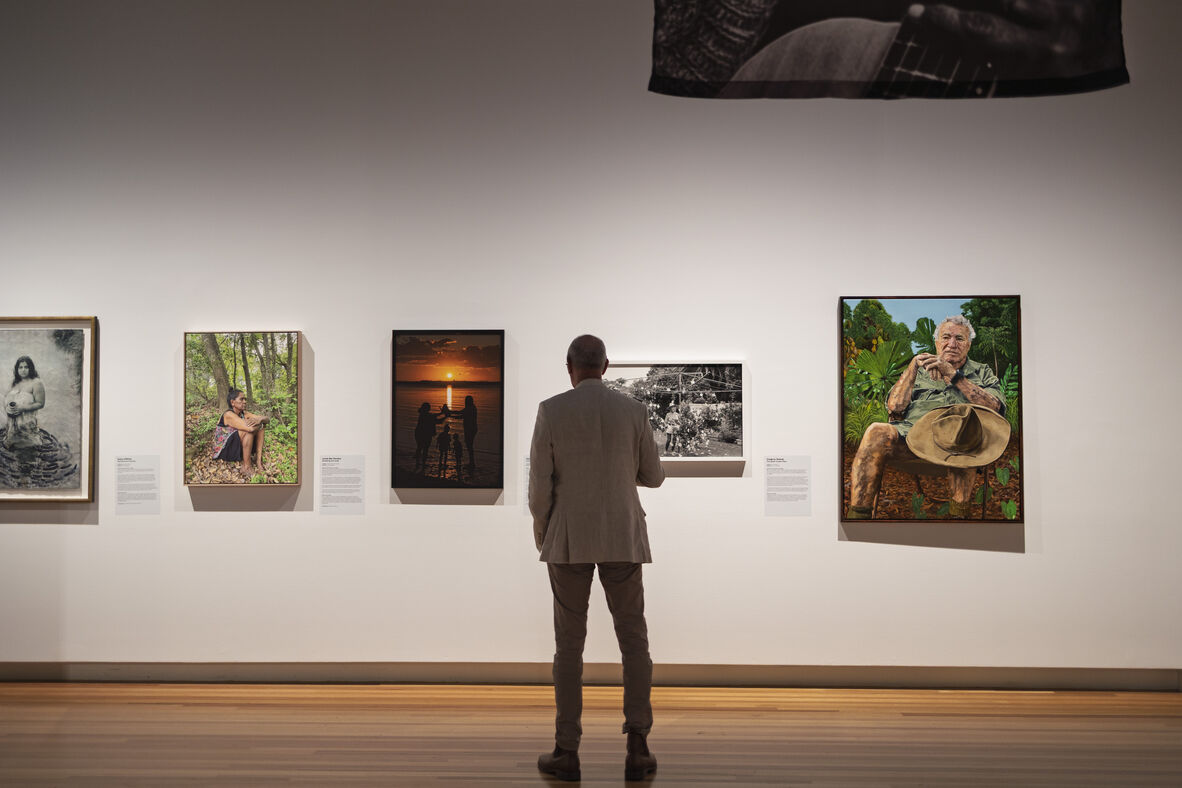 Man looking at Brisbane Portrait Prize exhibition