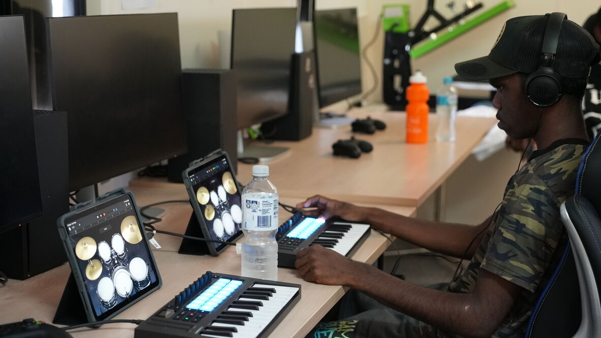 Doomadgee IKC patron composing music on digital keyboard and iPad