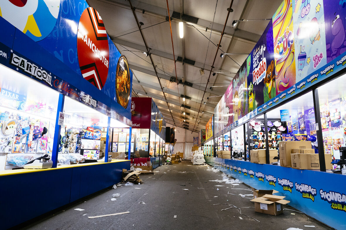 Alleyway of the sample pavillion at the Ekka, without any crowds or people, showing rubbish and piece sof paper on the ground