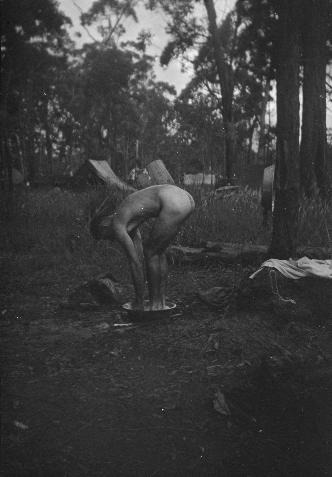 Soldier bathing in a small basin outside camp near Kilcoy