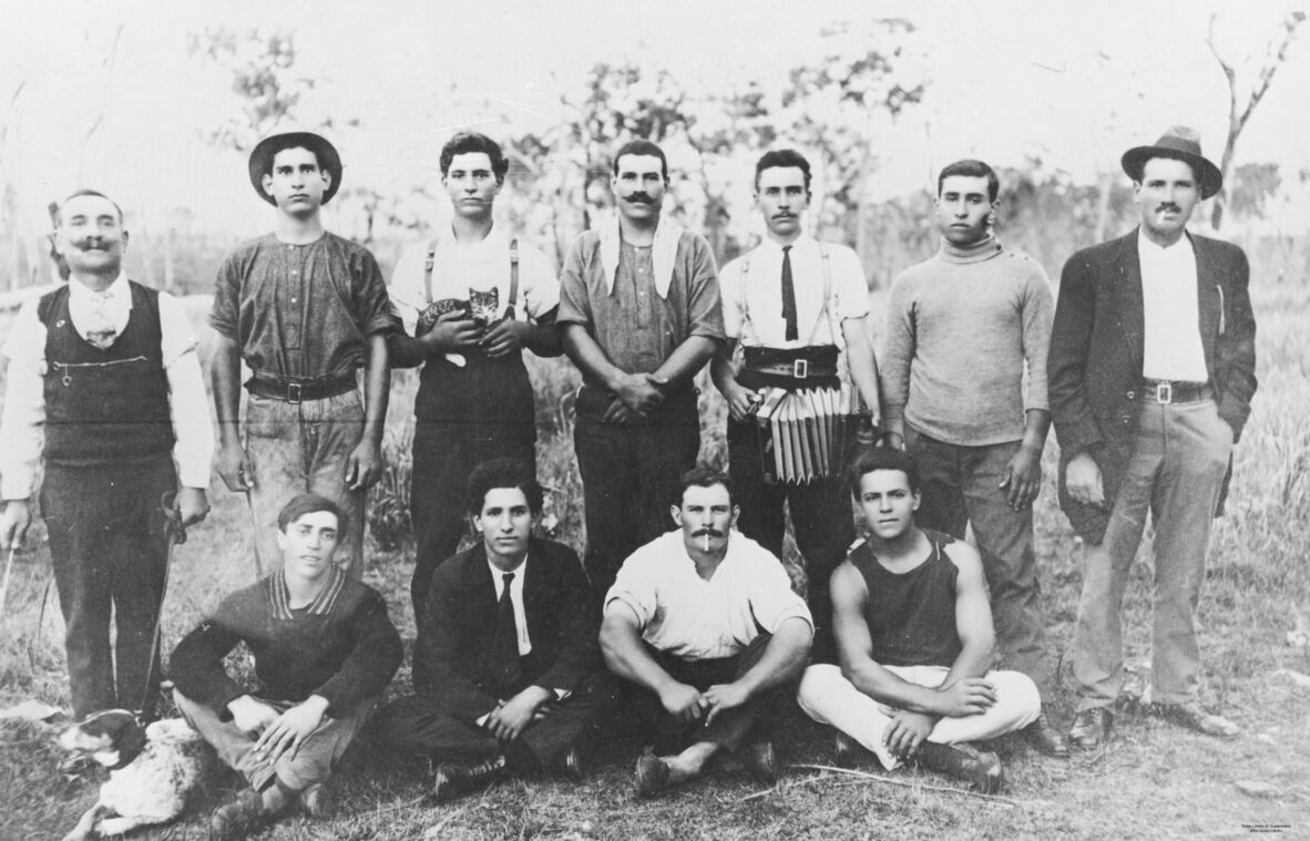  In the back row, third from the left, is Minas Logothetis holding a kitten. Fifth from the left is Anargeroo Megaloconomos holding an accordion. In the front row, second from the left, is Nicholas Logothetis. Fourth from the left is Peter Motis. All except three people of this gang were from the Greek island of Kythera (Description supplied with photograph).