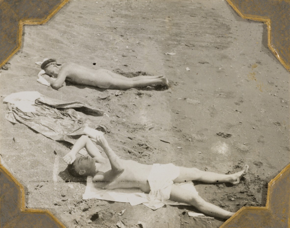 Maurie Harland and Colin Reid lying on Malahang beach, Papua New Guinea