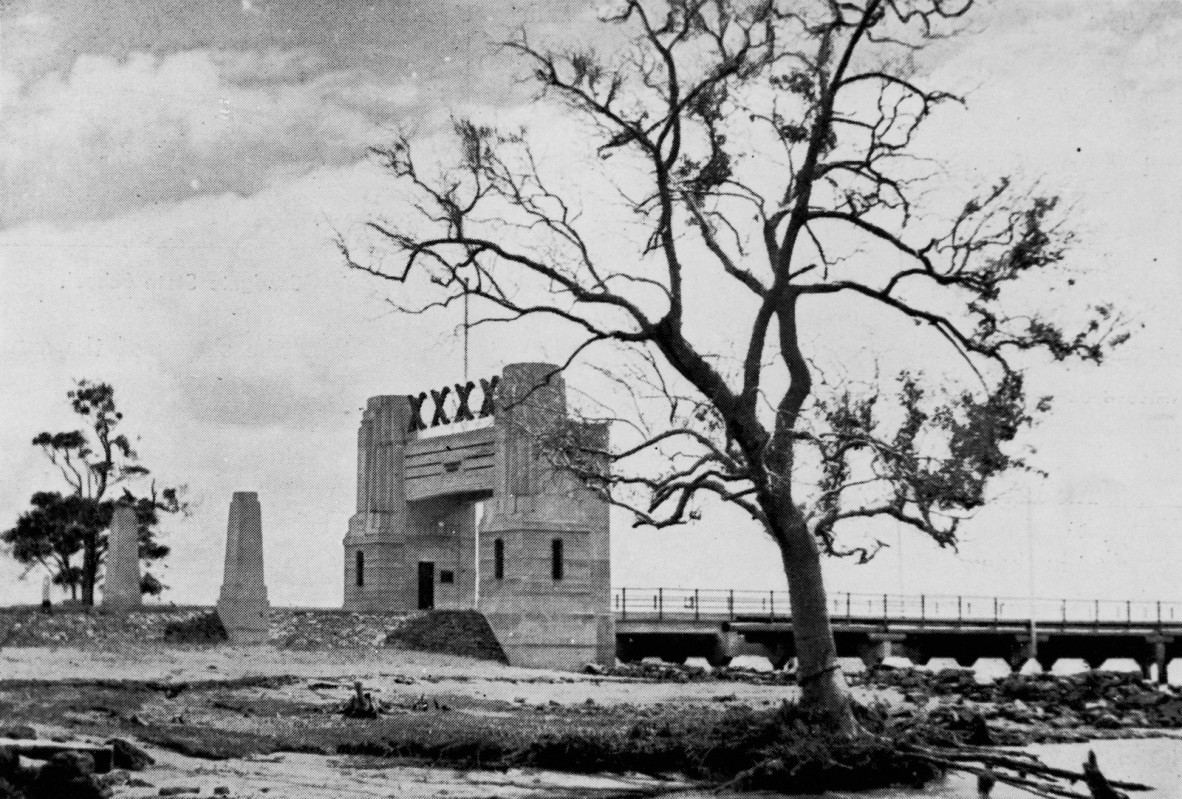  Entrance to the Hornibrook Highway from Sandgate, Brisbane, 1939.  Pylons to mark the entrance to the Hornibrook Highway. The Fourex Brewery sign is above the gateway.