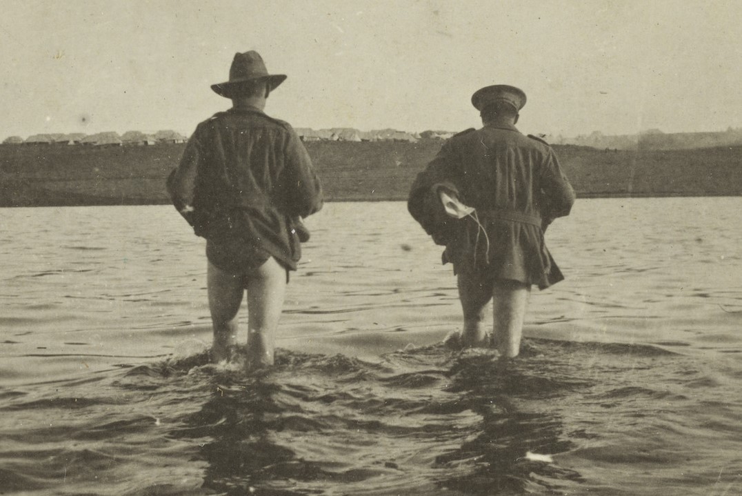 Two soldiers wading through knee-high water to reach a camp, Lemnos