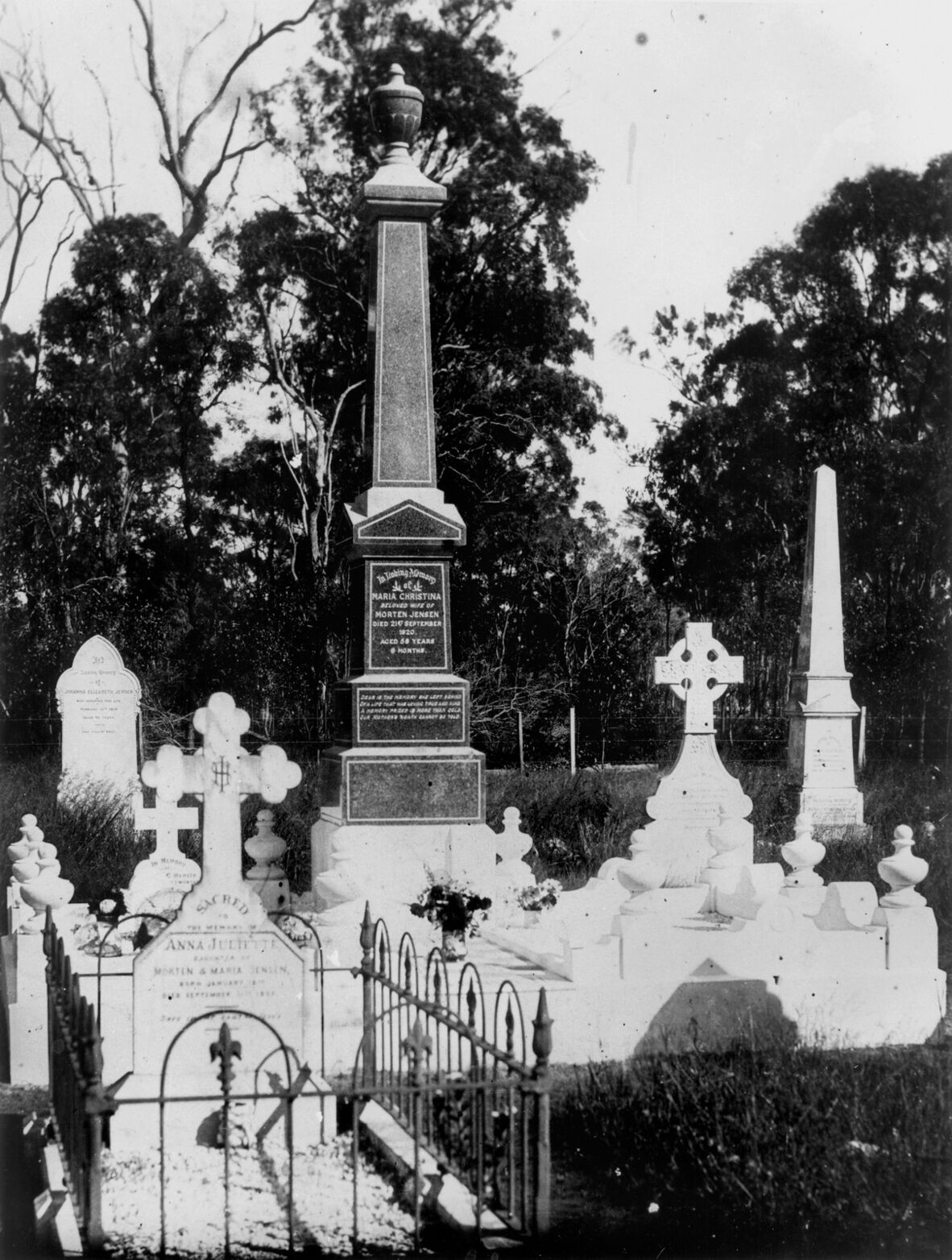 Black and white image of a number of headstones of various sizes at South Kolan Cemetery