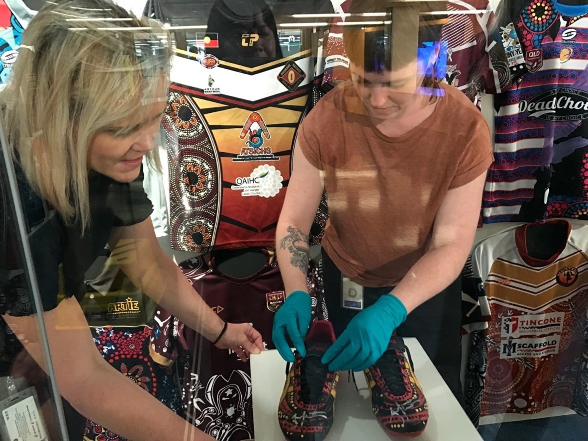 Senior conservator Rachel Spano and Conservation Technician Graduate, Amelia O’Donnell installing Jonathan Thurston’s football boots. 