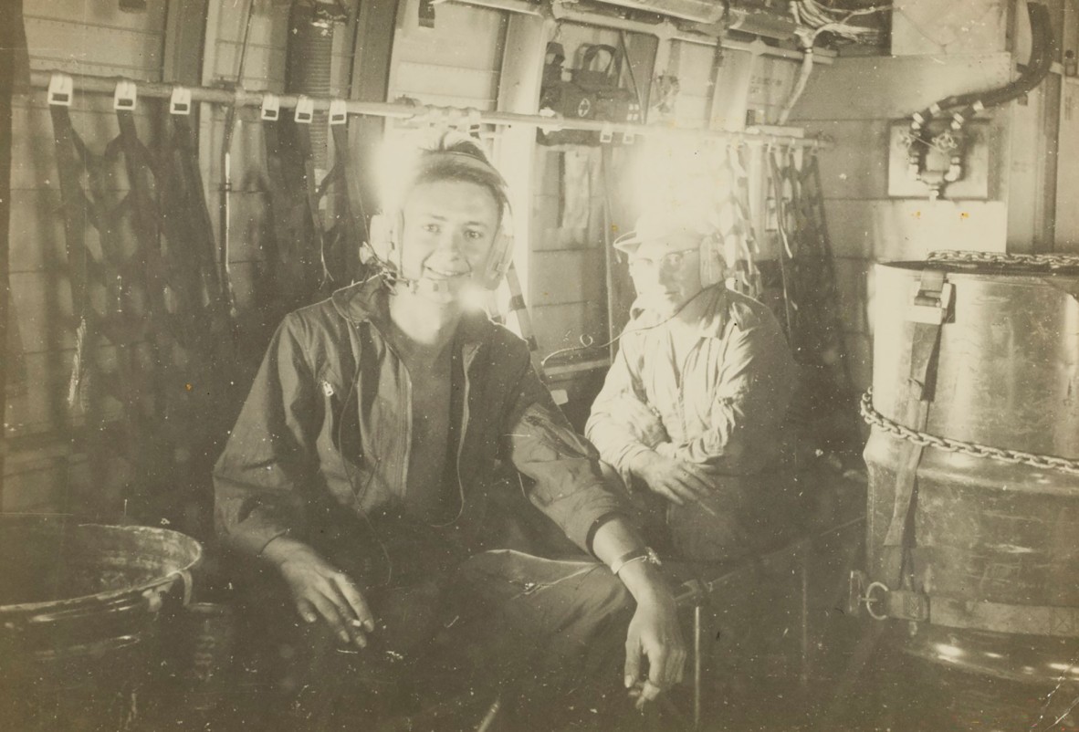 RAAF airman Jon Fallows with another serviceman, inside a military plane, Vietnam, 1968-1969, John Oxley Library, State Library of Queensland