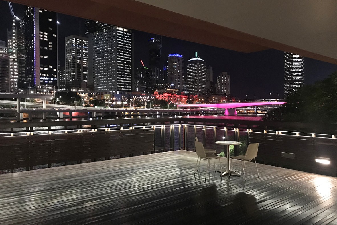 River deck overlooking the city skyline at night