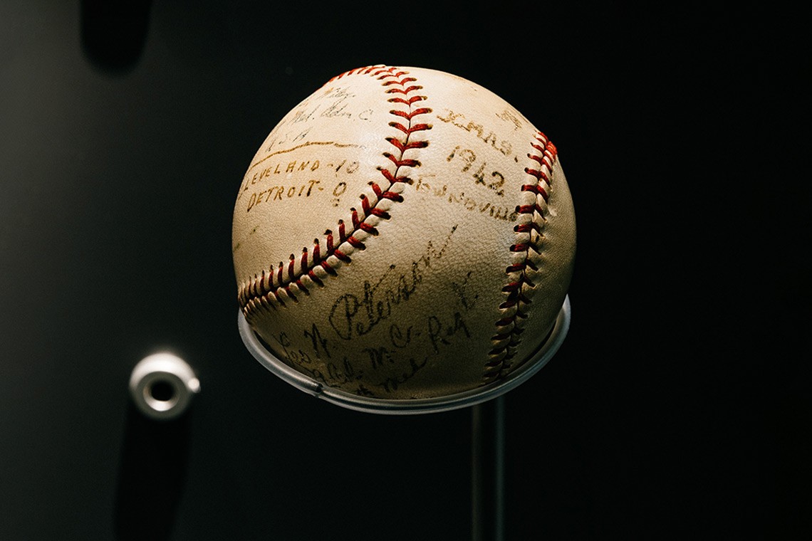 An American baseball which was used by some of the first American servicemen stationed in Townsville during a game played on Christmas Day 1942.   The baseball is cream coloured with red stitching and has been autographed by the players in black ink.