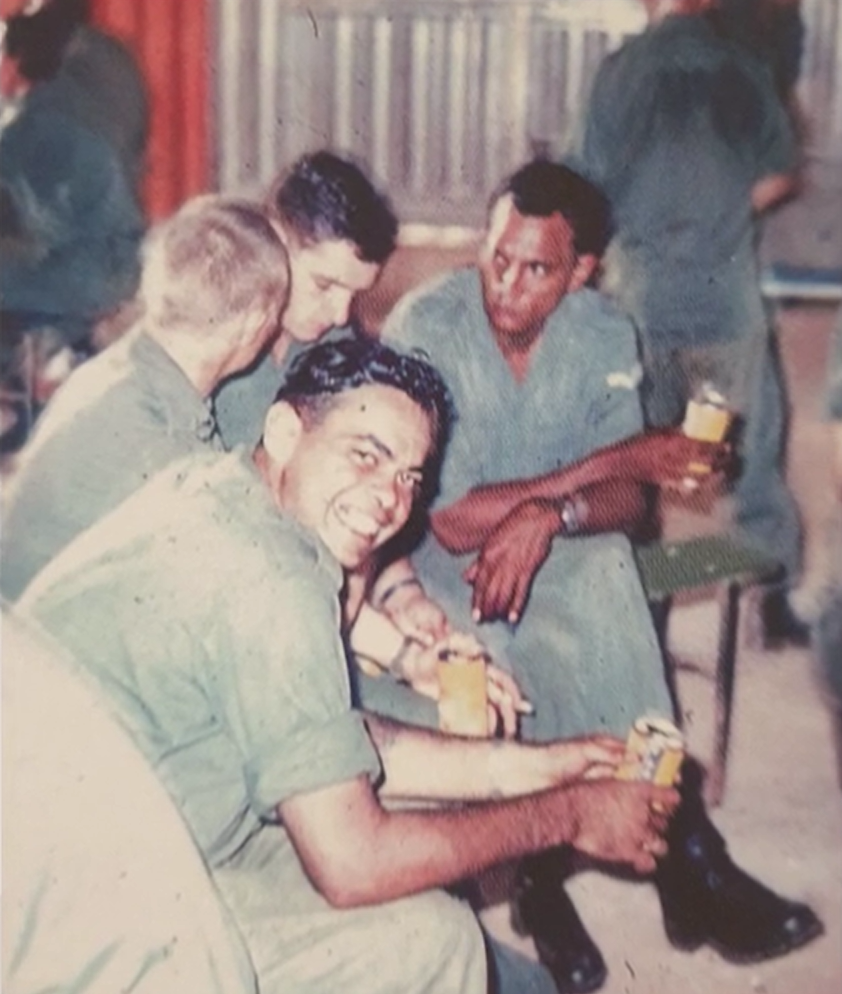 4 soldiers drink from cans while on duty in Vietnam