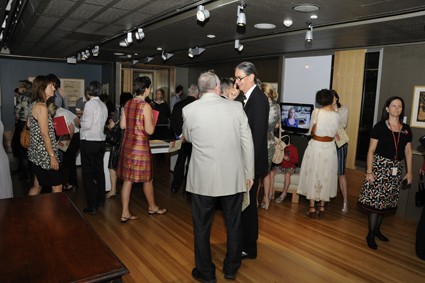 Visitors mingling at Art in Architecture exhibition opening