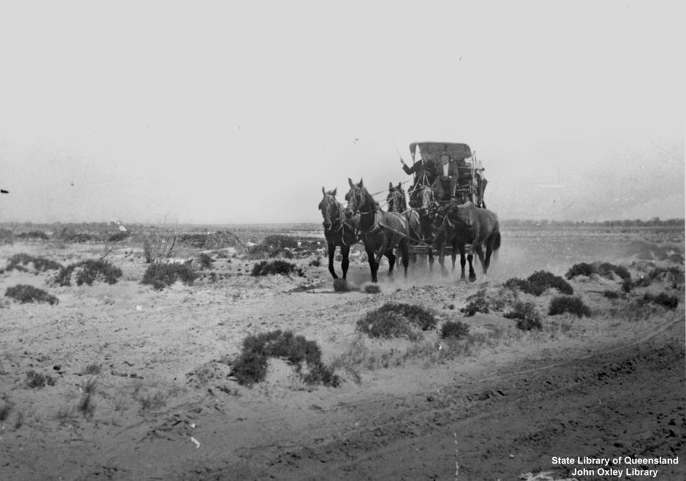 horse drawn cart in a desert-like landscape