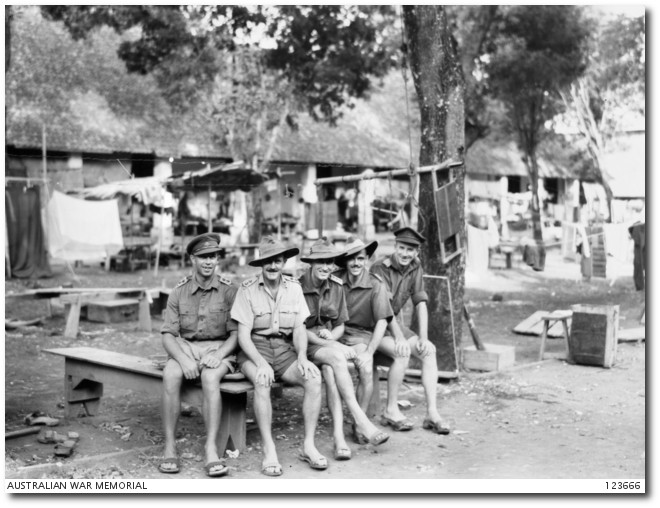 A group of Australian ex-prisoners sitting at "bicycle" camp, Senen, Java.