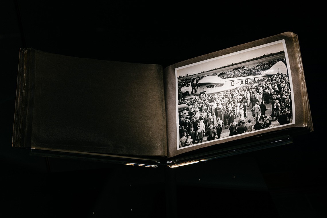 Black and white photograph of the aeroplane "Astraea' which visited Brisbane in June 1933. The image shows a side view of the aeroplane surrounded by a throng of men, women and children who had gathered to witness the event.