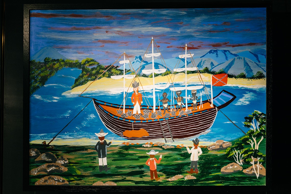 The painting entitled ""Twelve Turtles"" depicts the First Nations’ oral history of Captain Cook’s landing at Endeavour River.  The painting is acrylic on plywood and depicts Cook's ship in the Endeavour River with the twelve turtles, Captain Cook, and three Bama people onboard carrying spears.  Some of Cook's men are watching from the shore.