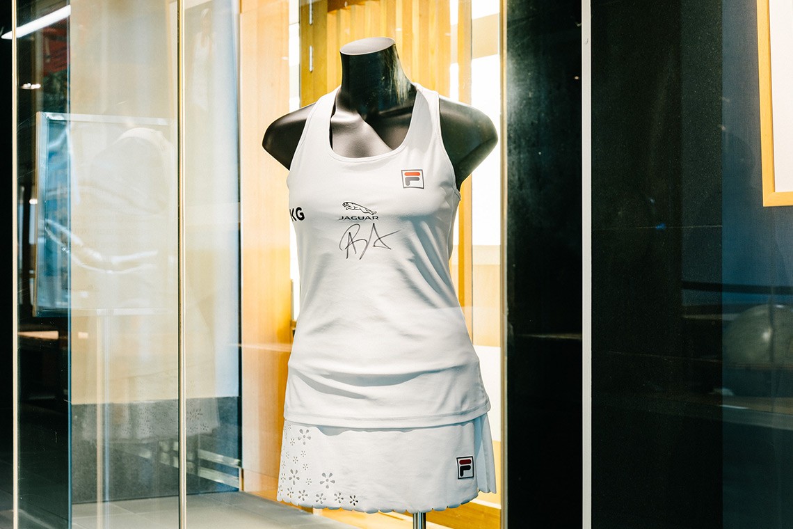 White, scallop-hemmed skort and top made for Australian tennis champion Ash Barty to wear during her 2021 Wimbledon campaign. The small daisy shaped flowers on the skort were laser cut from the fabric.  Ash Barty has signed her initials on the centre front of the top.