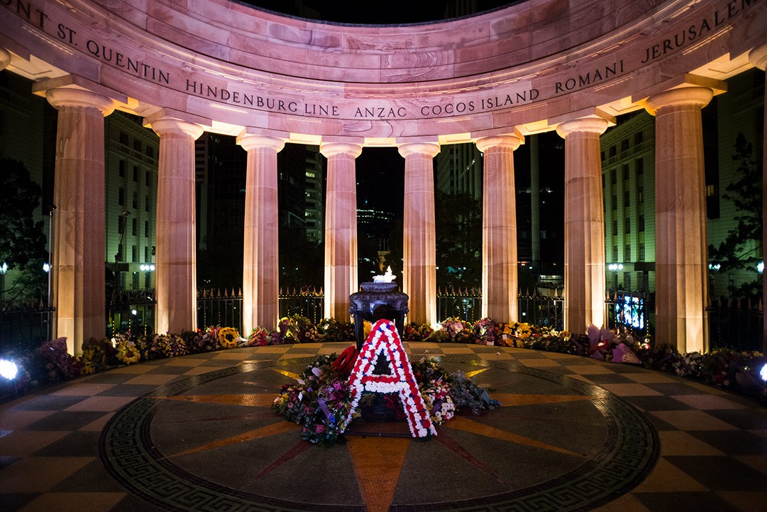 Wreaths surround the Eternal Flame at the Shrine of Remembrance on Anzac Day in Brisbane, Queensland, 2014