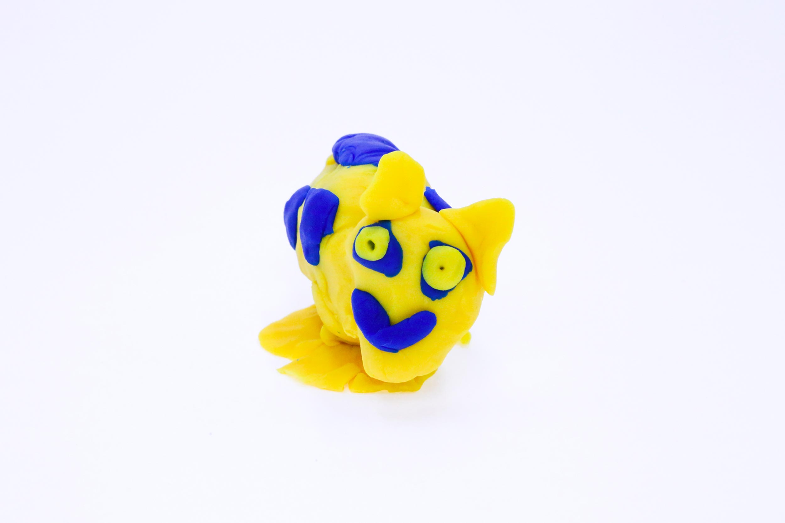 Chris Jnr is a yellow and blue play-dough sculpture that breathes fire and has bone crushing teeth.