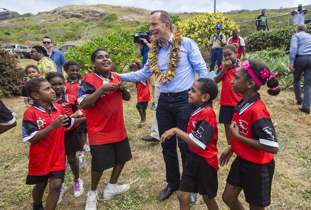 Former Prime Minister Tony Abbott Surrounded by school kids 