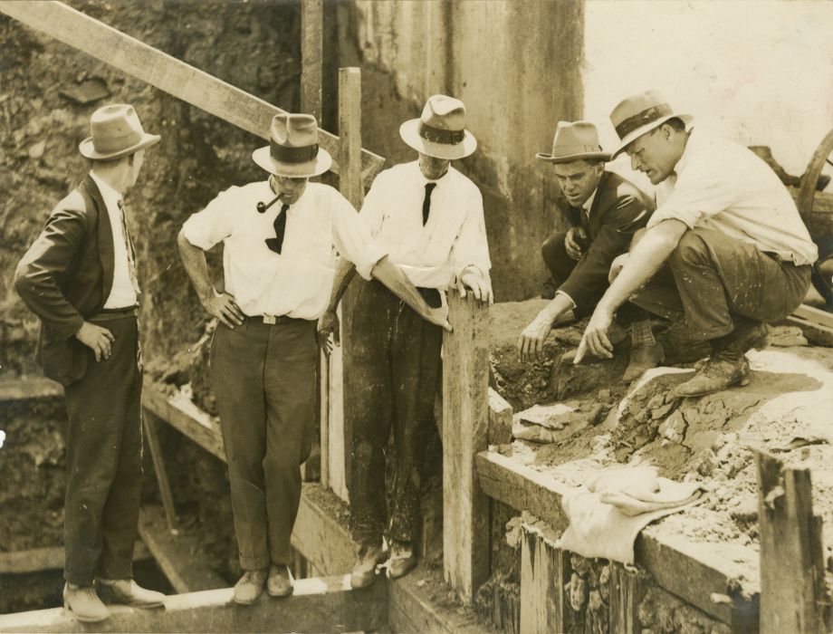 Problem solving and inspection of some foundation materials on site of the WIlliam Jolly Bridge construction. Manuel Hornibrook is on the right.