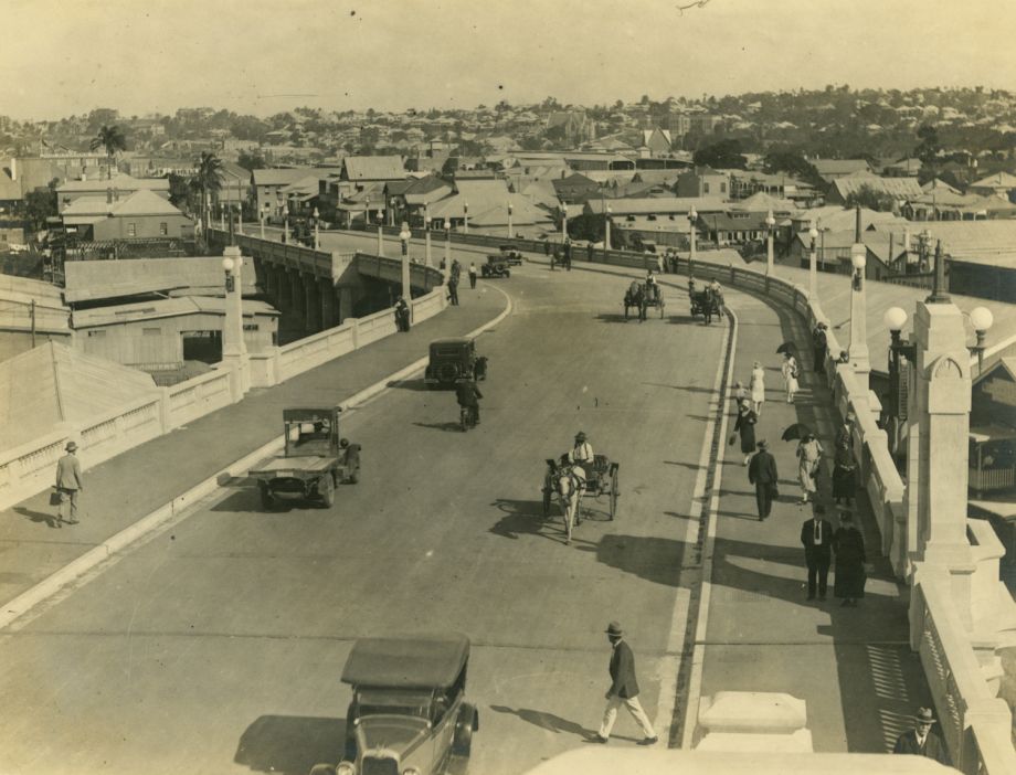 Photo taken after the opening of the Bridge, with a mix of traffic use visible including pedestrians, horses and carts, motorbikes, trucks and other vehicles.